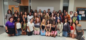 Women's Center student staff grouped in front of the center